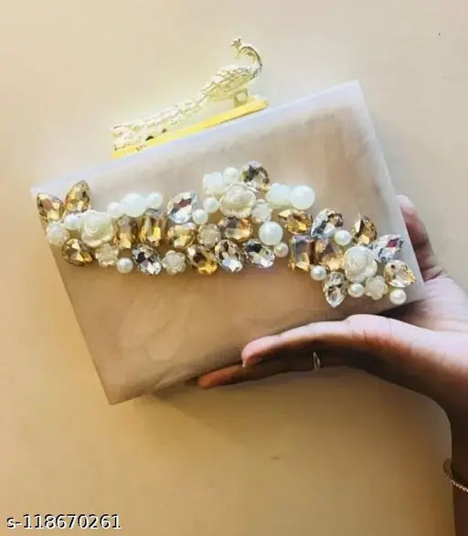 Handcrafted designer clutch with heavy studs and a patch, suitable for party looks