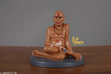 Brown marble Swami Samarth idol in sitting position, traditional religious decor for car dashboards and home offices