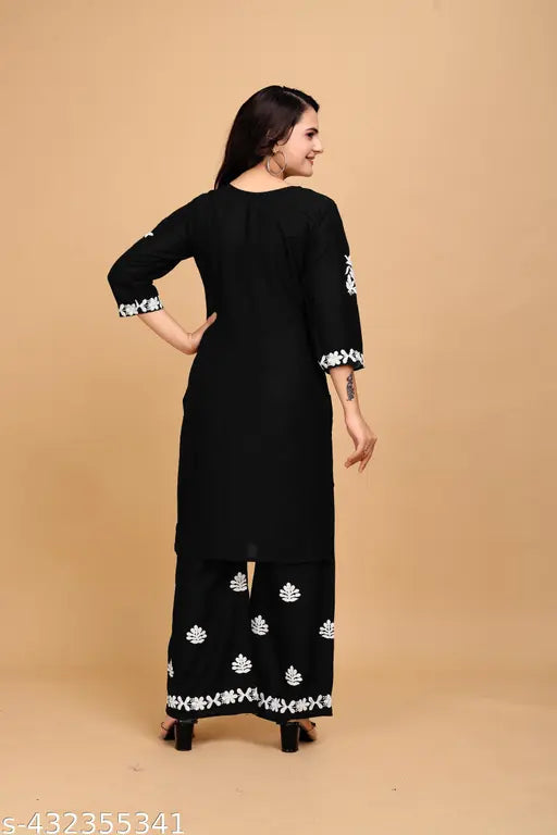 Black rayon kurta set with embroidered net bottomwear, three-quarter sleeves. Indian traditional clothing for women, available in sizes M to 4XL