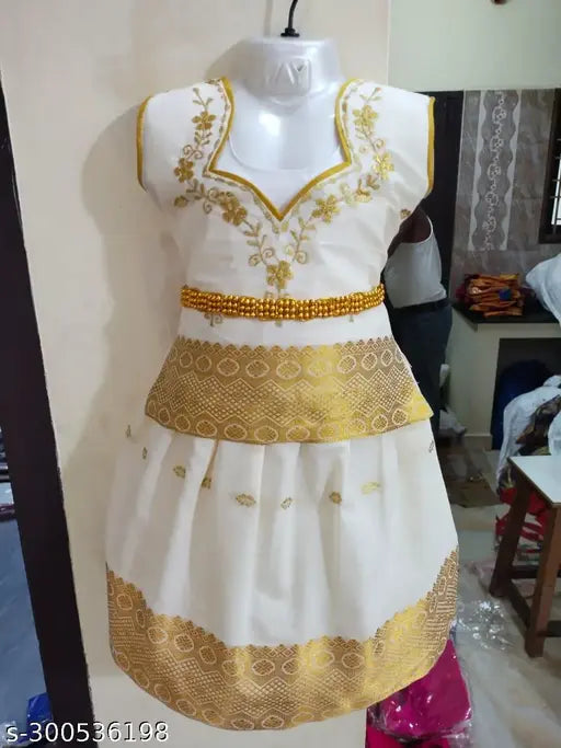 Kids girls Kerala Pattu Pavadai cotton silk shirt set with short sleeves, zari woven pattern on display