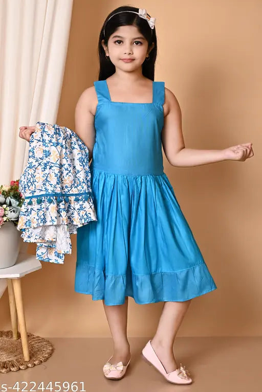 A young girl in a light blue dress with ruffles, white heels, holding a matching handbag