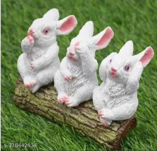 White ceramic rabbit figurines sitting on wooden tree trunk, faux fur accents, 5 inches tall
