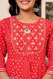 The image is of a person wearing a red kurta with sharara and dupatta