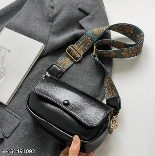 Trendy cross-body purse. This mini bag features a removable shoulder strap, and its design combines textile and leather materials with an Asian-inspired pattern