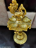 Golden peacock designer diya metal stand, intricately detailed Indian metalwork stand for traditional diyas
