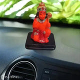 Orange polyresin Hanuman ji idol for car dashboard, symbolic of strength and good luck