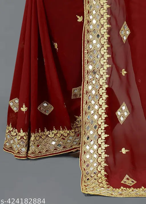 A red and gold embroidered georgette saree with mirror work, suitable for festivals and weddings