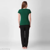 Green top and black pants in style