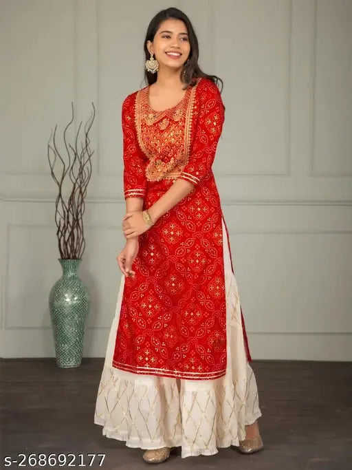 Red and gold traditional kurti set for women, embroidered with intricate patterns, suitable for weddings