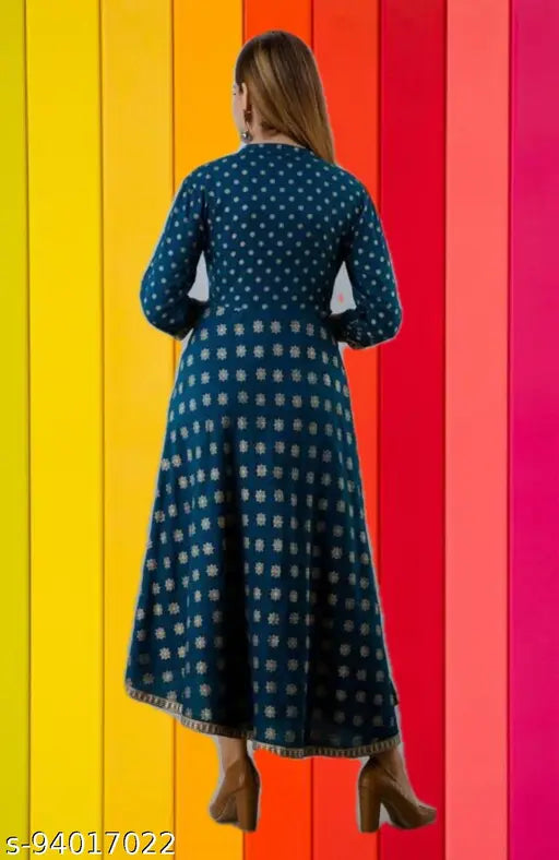 Woman wearing a long, flowing royal blue dress with gold print