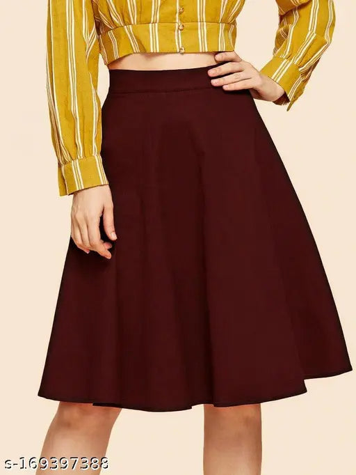 Yellow and white striped blouse with a round neckline. Belted waist, short sleeves. Solid magenta skirt over knee length pants. Woman wearing a belt and heels