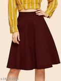 Yellow and white striped blouse with a round neckline. Belted waist, short sleeves. Solid magenta skirt over knee length pants. Woman wearing a belt and heels