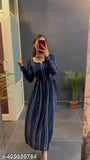 A woman in a blue, long-sleeve dress with print