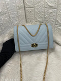 Quilted blue leather sling bag with twist lock, gold chain accents
