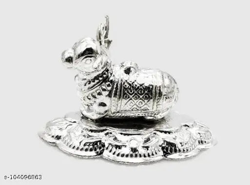 Silver plated Nandi temple idol, metal statue for puja rituals, small Indian artifact on altar