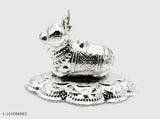 Silver plated Nandi temple idol, metal statue for puja rituals, small Indian artifact on altar