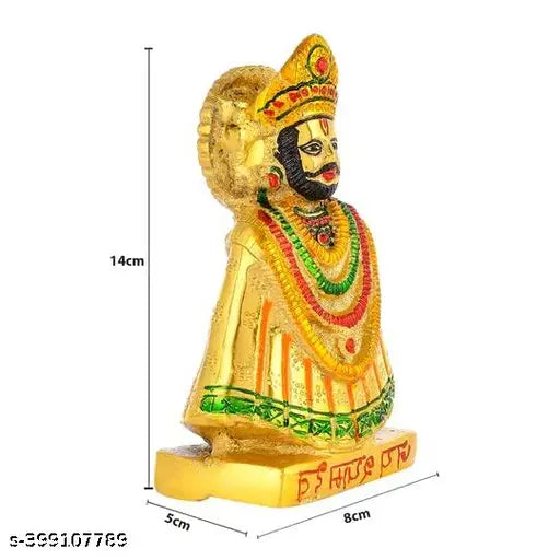Golden metal figure of a deity, ornate with jewelry and crown, temple decoration