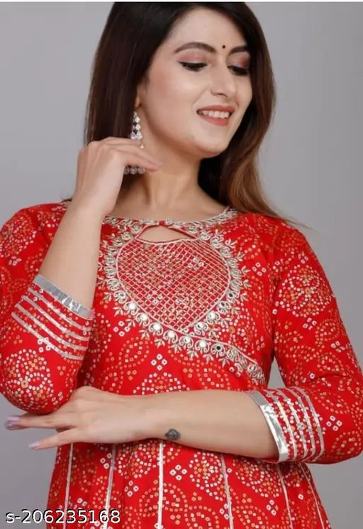 Red embroidered bandhani kurta with long sleeves and matching bottom