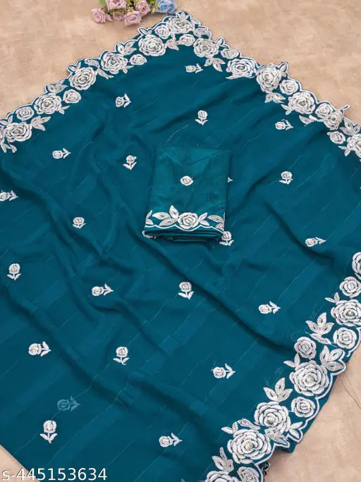 A radiant, embroidered sari and blouse with a floral pattern and sequin work