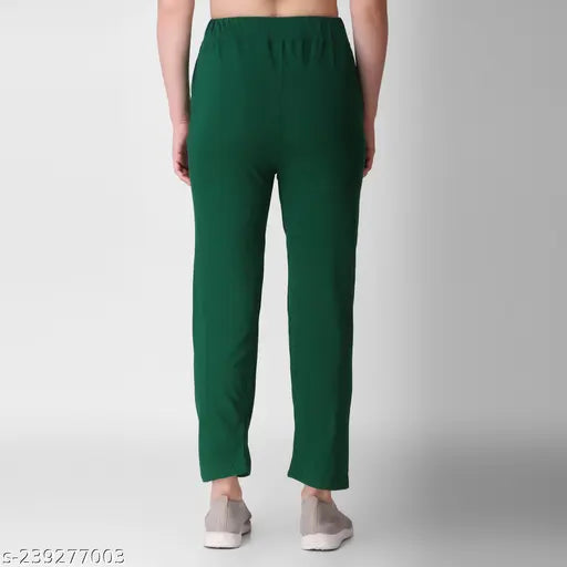 Dark teal or dark blue cropped pants with a zip fly, elastic waistband, side pockets, and relaxed fit