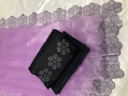 The image displays a piece of women's formal wear, specifically a saree with an accompanying blouse. The saree features an intricate pattern and appears to be made from organza fabric with additional decoration that includes lace and embellishments with what seems to be a combination of crystals and diamonds. The blouse has a lacy overlay with similar crystal and diamond detailing, and there is no visible text or branding on the items