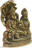 Yellow metal Lord Vishnu with Laxmi resting on Sheshnaag, intricately handcrafted polyresin idol from India, perfect for worship and home decor