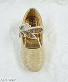 Gold mojari with a butterfly on top