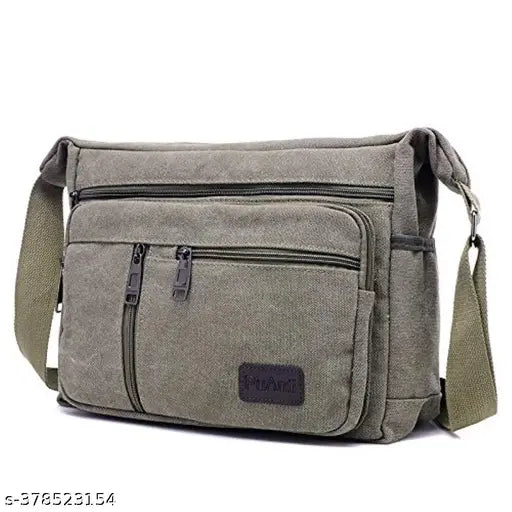 Green canvas cross-body sling bag with multiple pockets, shoulder strap. For travel, office, or business use