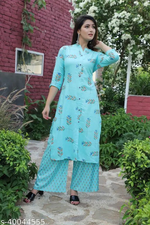 Rayon embroidered kurta with palazzos, printed net pattern, three-quarter sleeves. Women's ethnic Indian wear from India