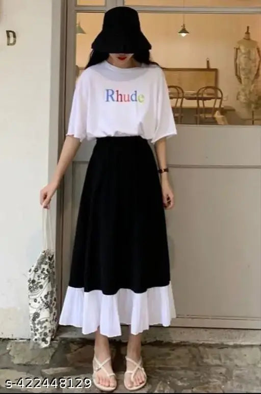 A person in a black bucket hat and high heels wearing a white blouse with the word "RHUD" on it, paired with a checkered skirt
