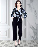 Multicolor floral printed long jumpsuit for women in Georgette fabric with long sleeves, featuring a vibrant print. Model wears size L (XS: 34-30-50, S: 36-32-50, M: 38-34-50, L: 40-36-50, XL: 42-38-50, XXL: 44-40-50, XXXL: 46-42-50). Made in India