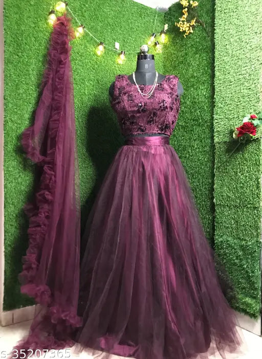 Wine-colored flared net lehenga choli with embroidery, free size and long length for women and girls. Indian ethnic wear for parties or festivals