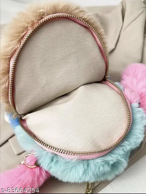 Trendy fuzzy sling bag with gold zipper, blue pom poms