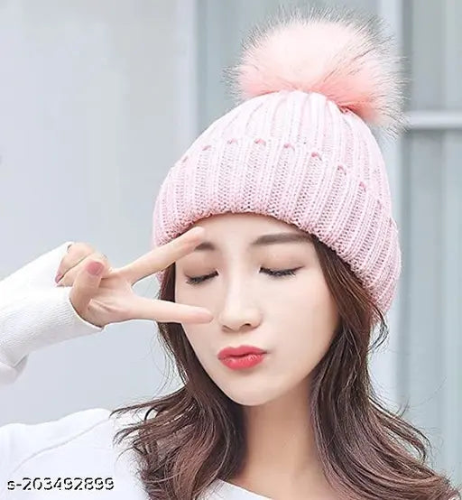 Pink velvet hat with fuzzy pom pom on top