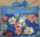 A set of 2 Elite Quilts with floral prints in blue, featuring white and pink flowers, presented on a plaid background