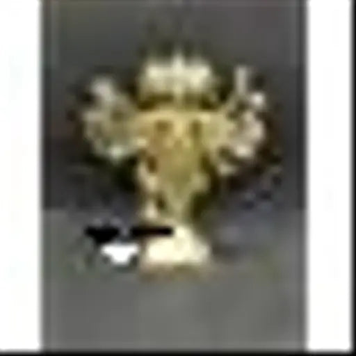 Gold metal idol with multiple arms, traditional design on a dark background