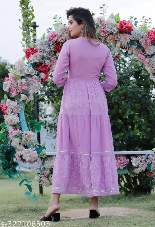 Purple and white embroidered tyer kurta with long skirt, decorated with flowers