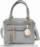 Grey leather sling bag with fringe details and multiple pockets