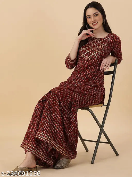Red patterned embroidered women's kurta and matching saree
