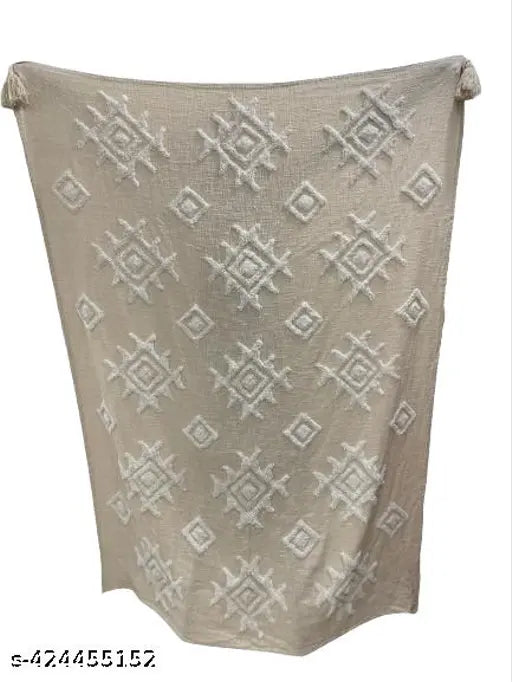 Soft, light brown handwoven throw with patterned detailing