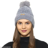 Grey soft winter beanie cap with fur lining and a pom-pom on top