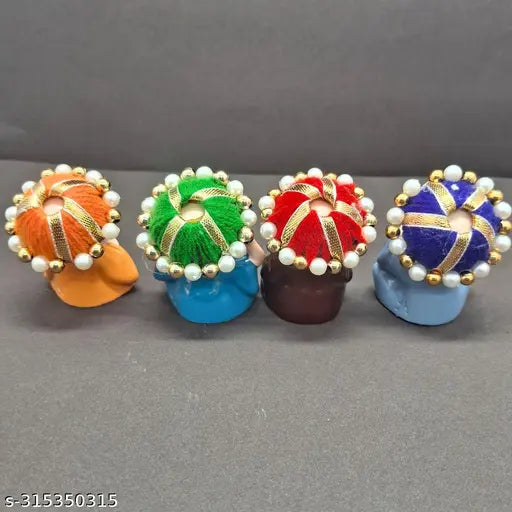Multicolor Alaukik polyresin baby monk Buddha idols (4 pcs) - Indian-crafted home decor with calm, positive energy