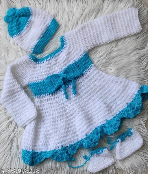 White and blue handmade acrylic woolen frock/sweater with cap and booties for baby girl on display