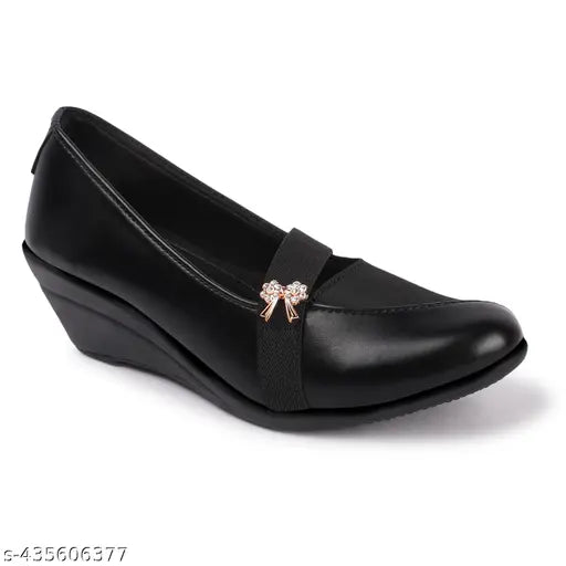Black synthetic wedge-heeled loafers with metallic buckle and bow accents