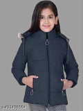 A young girl standing in a black parka with fur lining, hood up and zip closed
