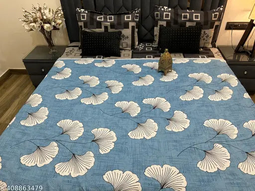Dasha Tulip Quilt with blue and white floral pattern and multiple layers
