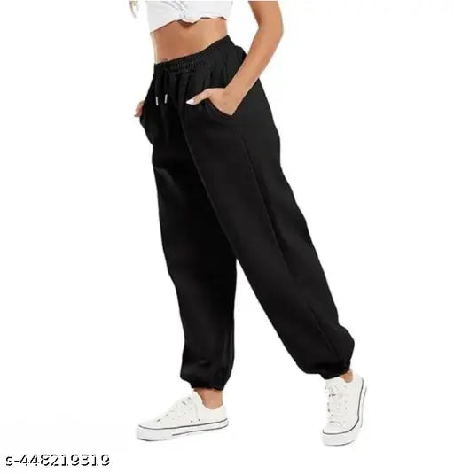 Black cotton joggers with elastic waistband, zip fly, and two side pockets