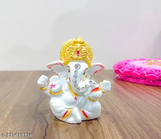White polyresin Ganesh idol, gold accents and accessories