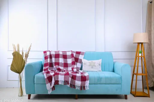 A white and blue throw blanket cover for a 2-seater sofa