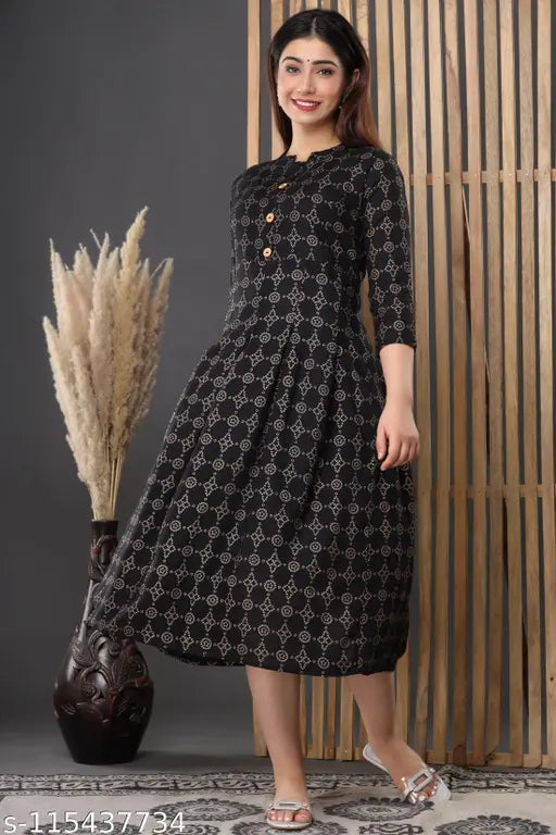 A woman in a black rayon maternity kameez